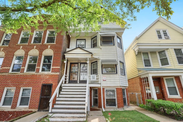 townhome / multi-family property with fence and brick siding