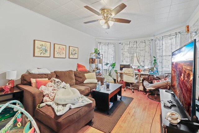 living area featuring wood-type flooring, a ceiling fan, and a wealth of natural light