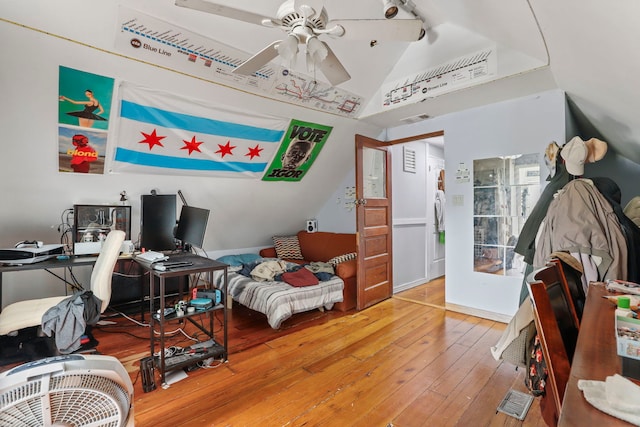 bedroom featuring visible vents, vaulted ceiling, and hardwood / wood-style floors