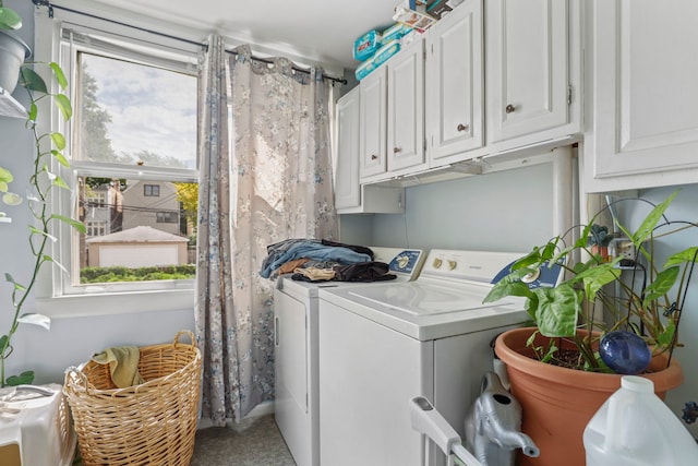 laundry room with a healthy amount of sunlight, cabinet space, and washing machine and clothes dryer