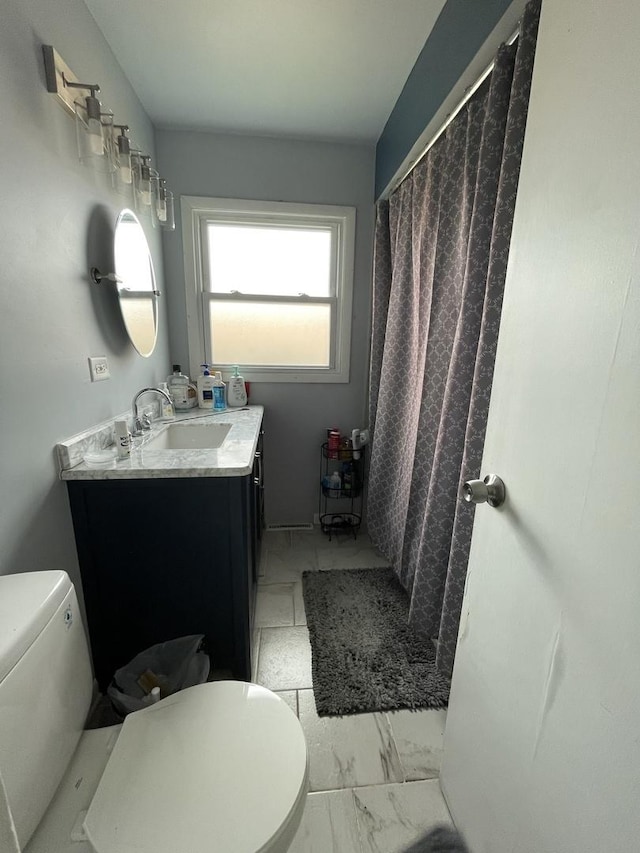 full bathroom featuring toilet, marble finish floor, vanity, and a shower with curtain