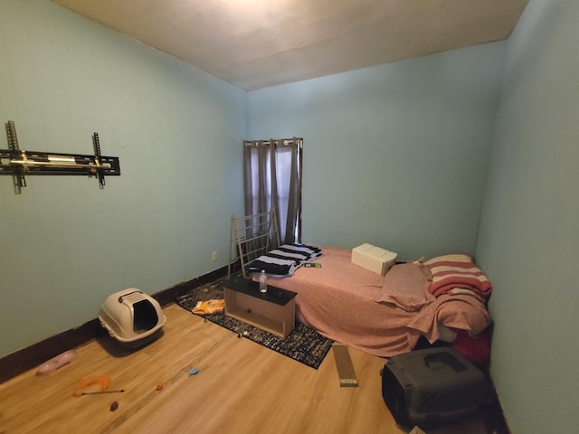 bedroom with hardwood / wood-style floors