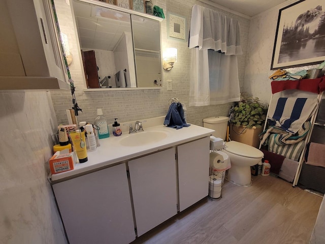 bathroom featuring hardwood / wood-style flooring, vanity, and toilet