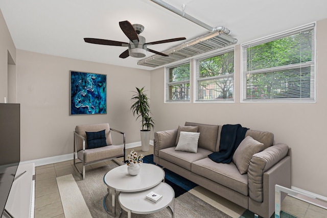 tiled living room with ceiling fan and plenty of natural light