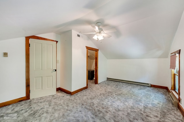 additional living space featuring ceiling fan, baseboard heating, vaulted ceiling, and light carpet