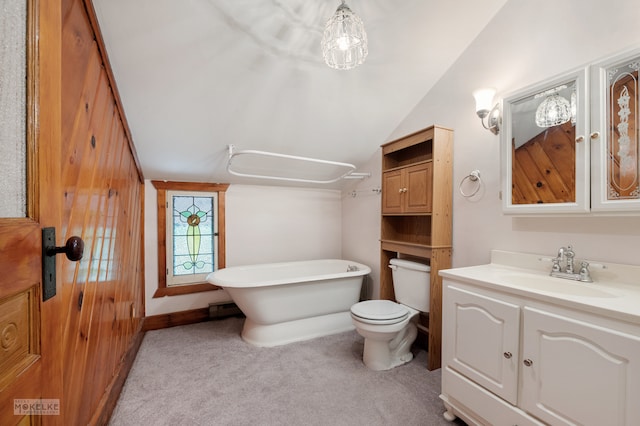 bathroom featuring vaulted ceiling, toilet, and vanity