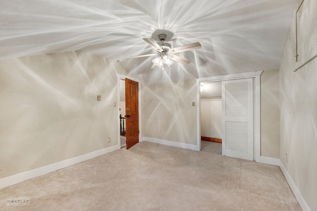 additional living space featuring ceiling fan and light carpet