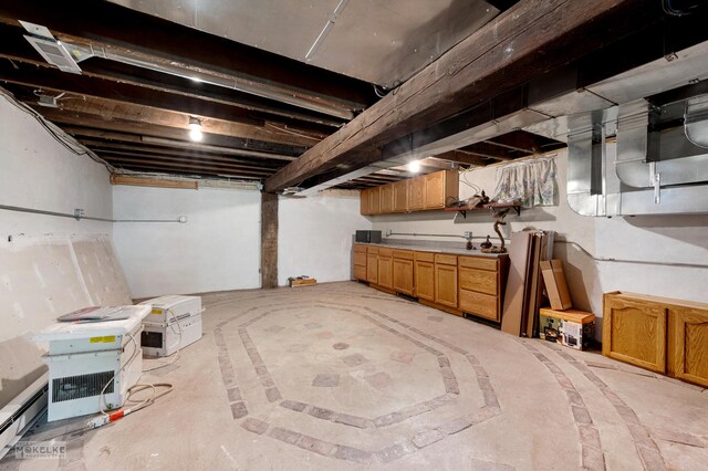 basement with a baseboard heating unit