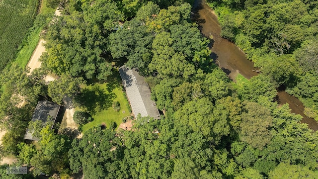 bird's eye view with a wooded view