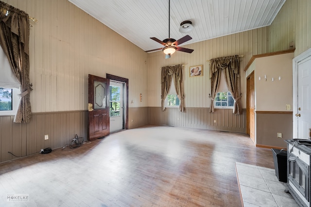 living room with wood walls, hardwood / wood-style flooring, wooden ceiling, ceiling fan, and lofted ceiling