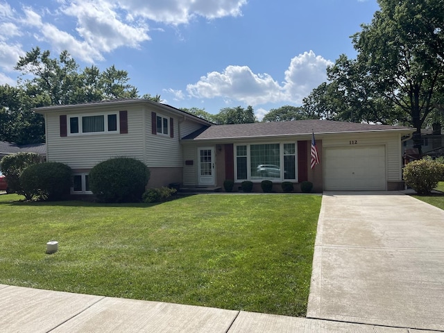 split level home featuring a garage and a front lawn