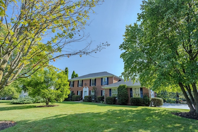 colonial-style house with a front lawn