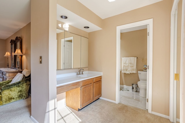 bathroom with toilet, vanity, and tile patterned floors