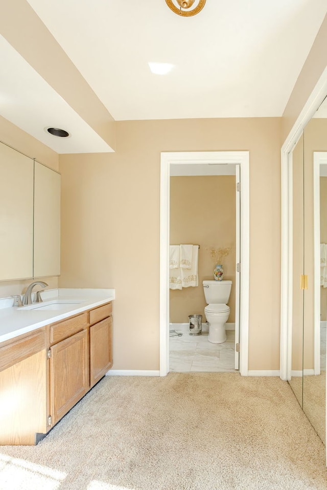 bathroom featuring tile patterned flooring, toilet, and vanity