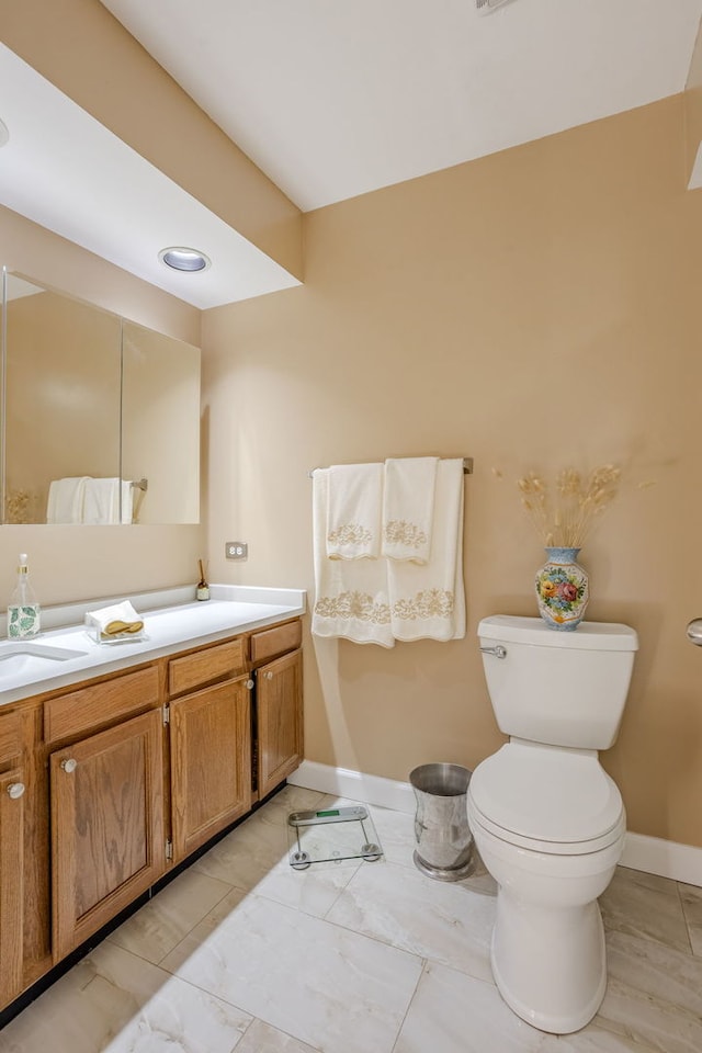 bathroom with tile patterned flooring, vanity, and toilet