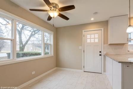 interior space with ceiling fan, baseboards, and recessed lighting