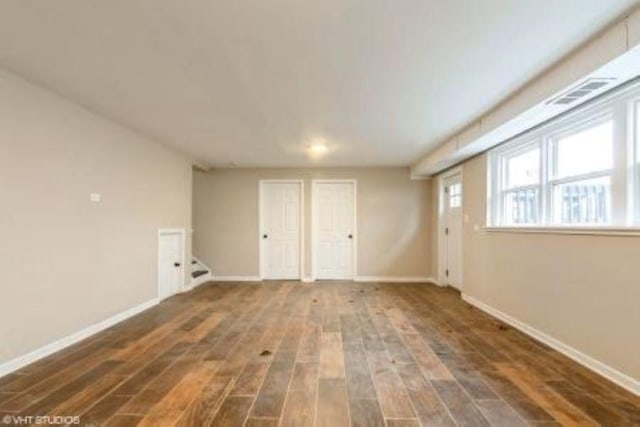 interior space featuring baseboards and wood finished floors