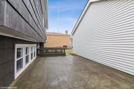 view of side of property featuring a patio area