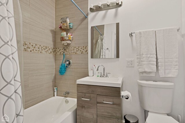 full bathroom with toilet, shower / bathtub combination with curtain, and vanity