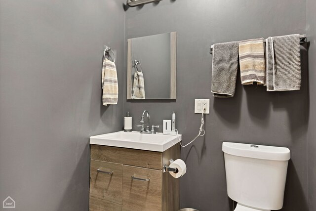 bathroom featuring vanity and toilet