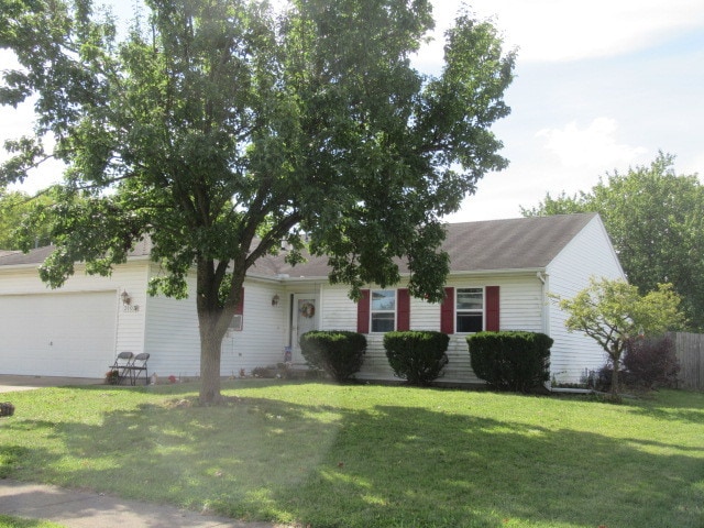 single story home featuring a front yard and a garage