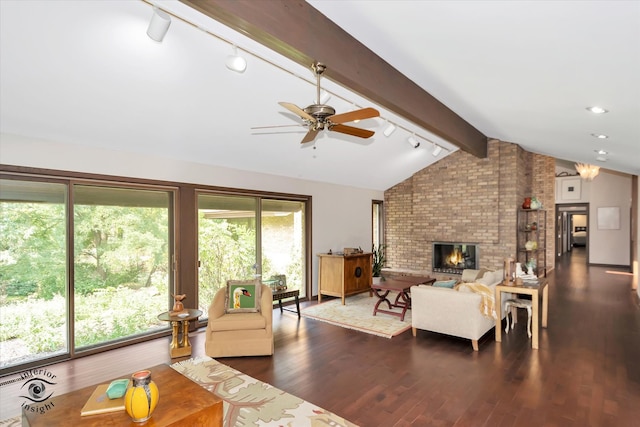 living room with ceiling fan, a brick fireplace, dark hardwood / wood-style flooring, and lofted ceiling with beams