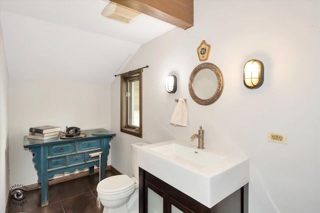 bathroom featuring vanity, toilet, tile patterned flooring, and vaulted ceiling with beams