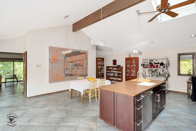 kitchen with a wealth of natural light, sink, a center island with sink, and ceiling fan