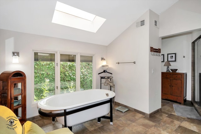 interior space with vaulted ceiling with skylight and a washtub