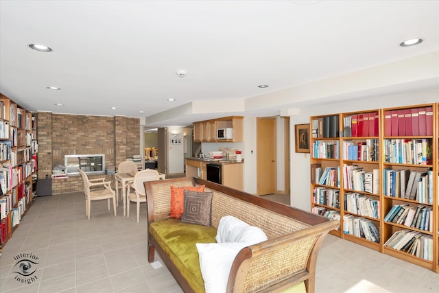 sitting room featuring a brick fireplace and light tile patterned flooring