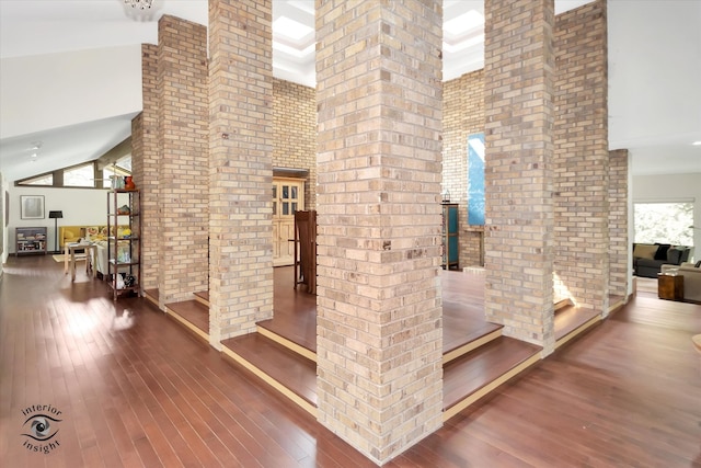 interior space with high vaulted ceiling, wood-type flooring, and a wealth of natural light