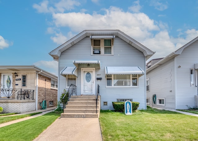 bungalow-style home featuring a front yard