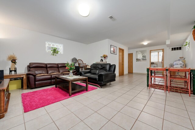 living room with a healthy amount of sunlight and light tile patterned floors