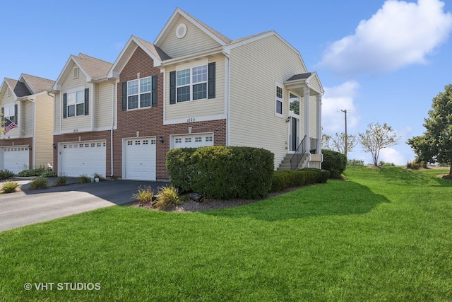 view of front of home with a front yard and a garage