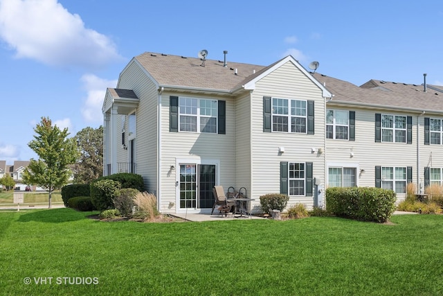 rear view of property featuring a lawn and a patio