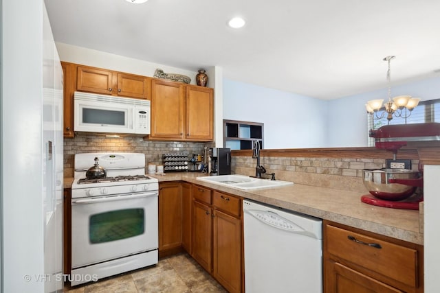 kitchen featuring decorative backsplash, white appliances, sink, decorative light fixtures, and a notable chandelier