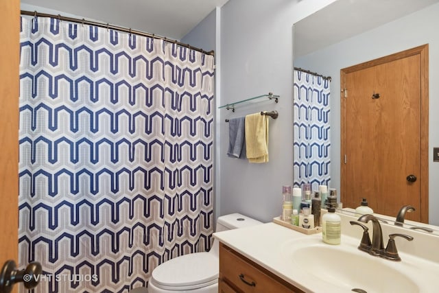 bathroom featuring vanity, a shower with shower curtain, and toilet