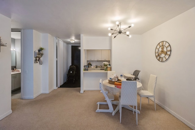 dining room featuring light carpet and a chandelier