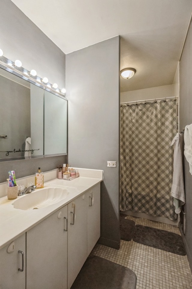 bathroom featuring tile patterned floors, vanity, and walk in shower