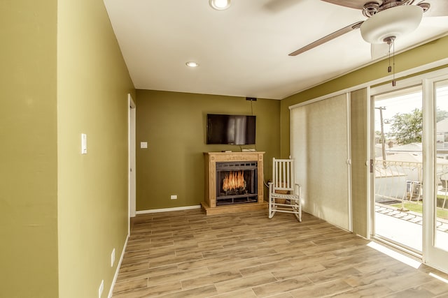 unfurnished living room featuring light hardwood / wood-style floors and ceiling fan