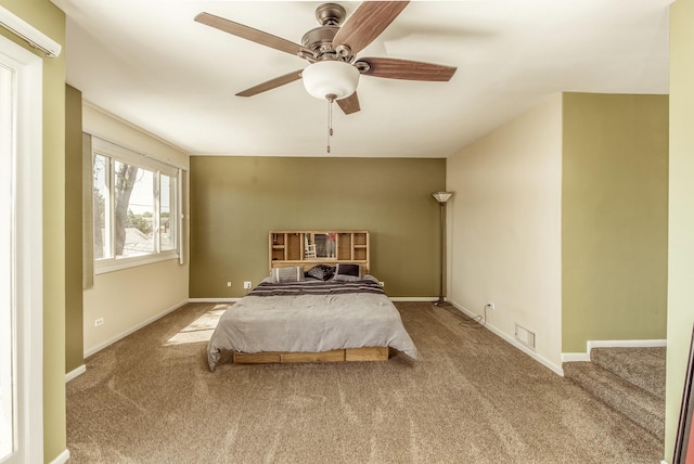 carpeted bedroom with a ceiling fan, visible vents, and baseboards