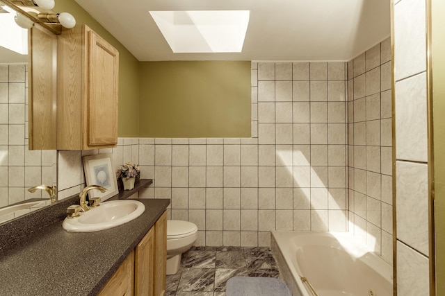 full bath featuring vanity, toilet, marble finish floor, and tile walls