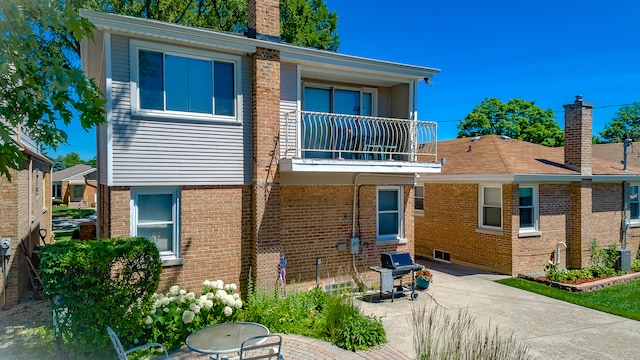 back of house with a patio area and a balcony