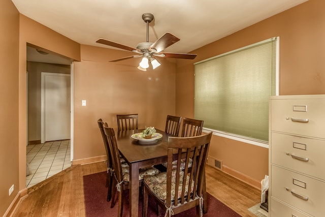 dining room with light wood-type flooring and ceiling fan