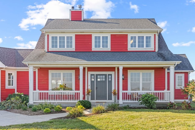 view of front facade featuring a front yard and covered porch