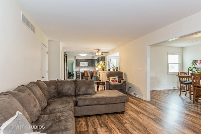 15312 Sunshine Cir, Plainfield, IL 60544 - living area with dark wood-style flooring, healthy amount of natural light, baseboards, and ceiling fan