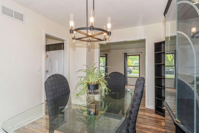 15312 Sunshine Cir, Plainfield, IL 60544 - dining area featuring a chandelier, dark wood finished floors, and baseboards