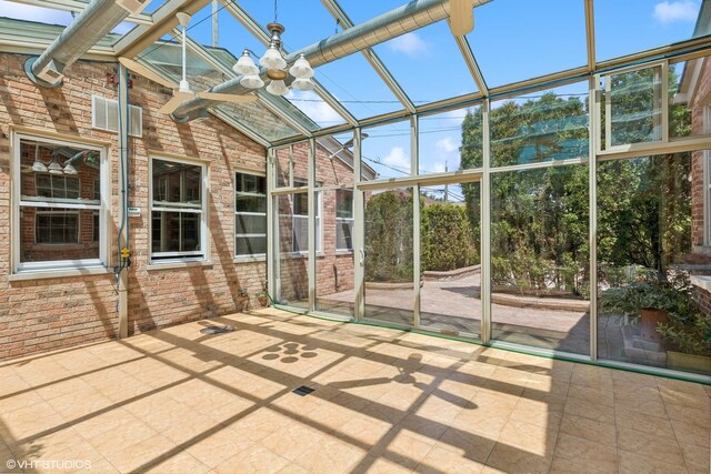 unfurnished sunroom with plenty of natural light and a notable chandelier