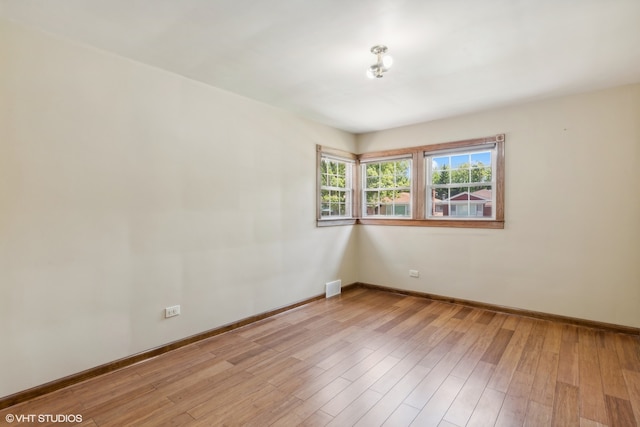 unfurnished room featuring light hardwood / wood-style floors