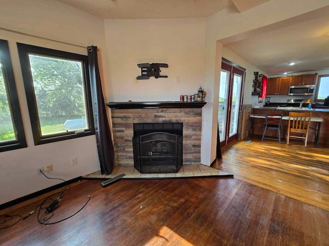 living room with light wood-type flooring and a fireplace